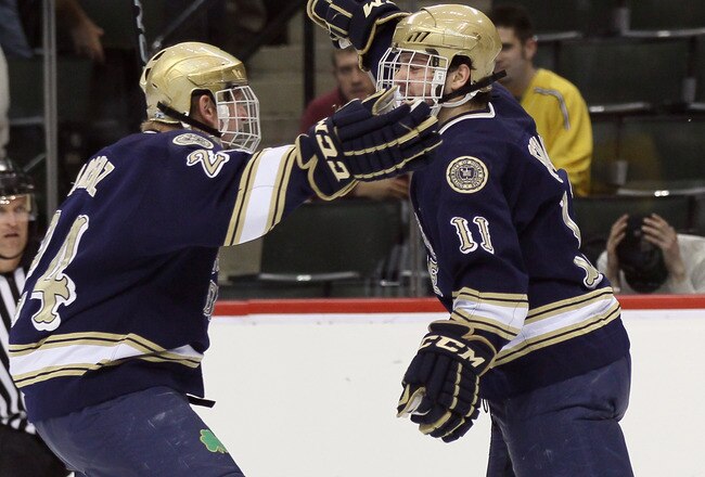 ST. PAUL, MN - APRIL 07:  Jeff Costello #11 of the Notre Dame Fighting Irish celebrates his goal with Sean Lorenz #24 in the first period against the Minnesota Duluth Bulldogs  during semifinals of the 2011 NCAA Men's Frozen Four on April 7, 2011 at the Xcel Energy Center in St. Paul, Minnesota.  (Photo by Elsa/Getty Images)