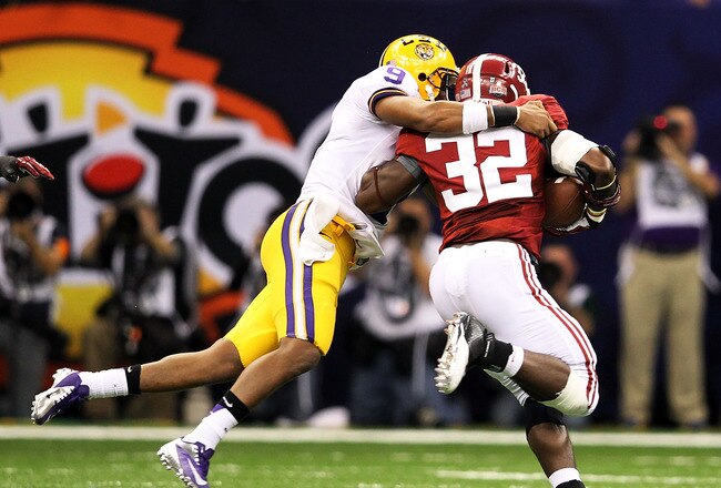 NEW ORLEANS, LA - JANUARY 09:  Jordan Jefferson #9 of the Louisiana State University Tigers tackles C.J. Mosley #32 of the Alabama Crimson Tide after throwing an interception to him in the third quarter during the 2012 Allstate BCS National Championship Game at Mercedes-Benz Superdome on January 9, 2012 in New Orleans, Louisiana.  (Photo by Andy Lyons/Getty Images)