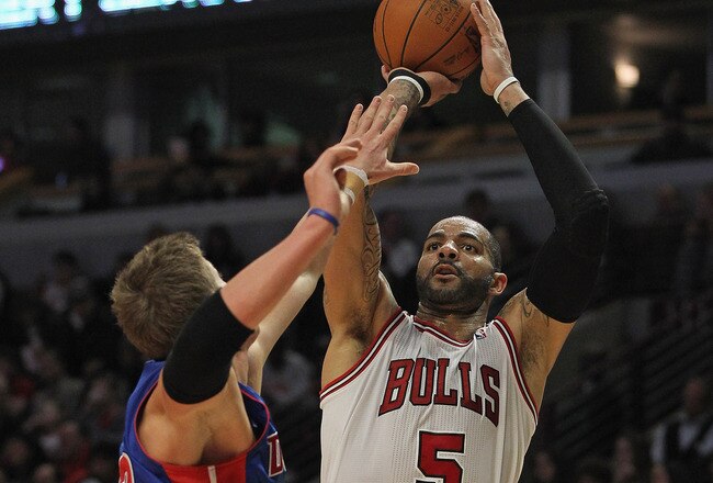 CHICAGO, IL - JANUARY 09: Carlos Boozer #5 of the Chicago Bulls puts up a shot over Jonas Jerebko #33 of the Detroit Pistons on his way to a game-high 23 points at the United Center on January 9, 2012 in Chicago, Illinois. The Bulls defeated the Pistons 92-68. NOTE TO USER: User expressly acknowledges and agrees that, by downloading and or using this photograph, User is consenting to the terms and conditions of the Getty Images License Agreement. (Photo by Jonathan Daniel/Getty Images)