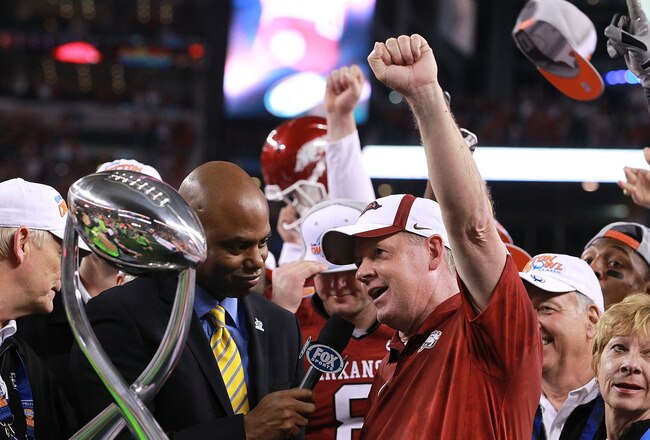 ARLINGTON, TX - JANUARY 06:  Head coach Bobby Petrino of the Arkansas Razorbacks celebrates the Cotton Bowl trophy after defeating the Kansas State Wildcats at Cowboys Stadium on January 6, 2012 in Arlington, Texas.  (Photo by Ronald Martinez/Getty Images)