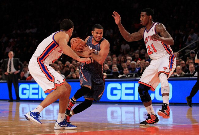NEW YORK, NY - JANUARY 09:  (C) D.J. Augustin #14 of the Charlotte Bobcats is challenged by (L) Landry Fields #2 of the New York Knicks and (R) Iman Shumpert #21 of the New York Knicks at Madison Square Garden on January 9, 2012 in New York City. NOTE TO USER: User expressly acknowledges and agrees that, by downloading and or using this photograph, User is consenting to the terms and conditions of the Getty Images License Agreement.  (Photo by Chris Trotman/Getty Images)