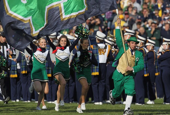 SOUTH BEND, IN - OCTOBER 29: The leprechaun and cheerleaders for the Notre Dame Fighting Irish run onto the field before a game against the Navy Midshipmen at Notre Dame Stadium on October 29, 2011 in South Bend, Indiana. (Photo by Jonathan Daniel/Getty Images)