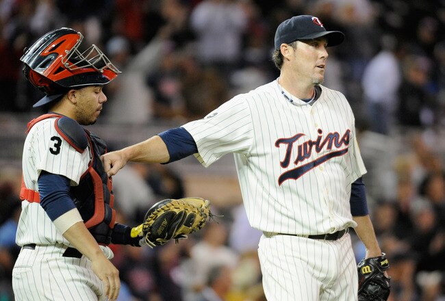 MINNEAPOLIS, MN - SEPTEMBER 27: Rene Rivera #32 and Joe Nathan #36 of the Minnesota Twins celebrate a win against the Kansas City Royals on September 27, 2011 at Target Field in Minneapolis, Minnesota. The Twins defeated the Royals 7-4. (Photo by Hannah Foslien/Getty Images)