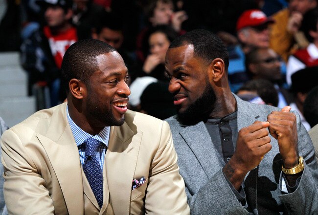 ATLANTA, GA - JANUARY 05:  LeBron James #6 and Dwyane Wade #3 of the Miami Heat converse on the bench during the game against the Atlanta Hawks at Philips Arena on January 5, 2012 in Atlanta, Georgia.  NOTE TO USER: User expressly acknowledges and agrees that, by downloading and or using this photograph, User is consenting to the terms and conditions of the Getty Images License Agreement.  (Photo by Kevin C. Cox/Getty Images)