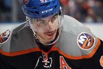 UNIONDALE, NY - NOVEMBER 23: John Tavares #91 of the New York Islanders displays the Islanders new third uniforms as he waits for a faceoff against the Philadelphia Flyers  at the Nassau Veterans Memorial Coliseum on November 23, 2011 in Uniondale, New York.  (Photo by Bruce Bennett/Getty Images)