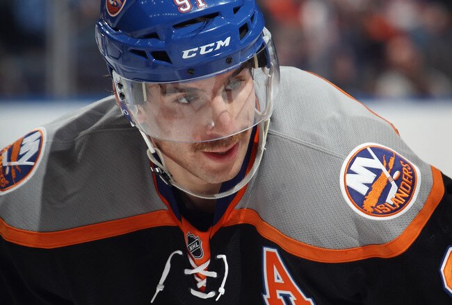 UNIONDALE, NY - NOVEMBER 23: John Tavares #91 of the New York Islanders displays the Islanders new third uniforms as he waits for a faceoff against the Philadelphia Flyers  at the Nassau Veterans Memorial Coliseum on November 23, 2011 in Uniondale, New York.  (Photo by Bruce Bennett/Getty Images)