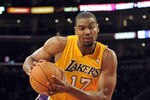 LOS ANGELES, CA - DECEMBER 19:  Andrew Bynum #17 of the Los Angeles Lakers turns as Brian Cook #34 of the Los Angeles Clippers falls during the game at Staples Center on December 19, 2011 in Los Angeles, California. NOTE TO USER: User expressly acknowledges and agrees that, by downloading and/or using this Photograph, user is consenting to the terms and conditions of the Getty Images License Agreement. Mandatory Copyright Notice: Copyright 2011 NBAE  (Photo by Harry How/Getty Images)