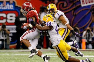 NEW ORLEANS, LA - JANUARY 09:  Trent Richardson #3 of the Alabama Crimson Tide breaks a tackle from Barkevious Mingo #49 of the Louisiana State University Tigers on his way to a 34-yard touchdown run in the fourth quarter during the 2012 Allstate BCS National Championship Game at Mercedes-Benz Superdome on January 9, 2012 in New Orleans, Louisiana.  (Photo by Kevin C. Cox/Getty Images)