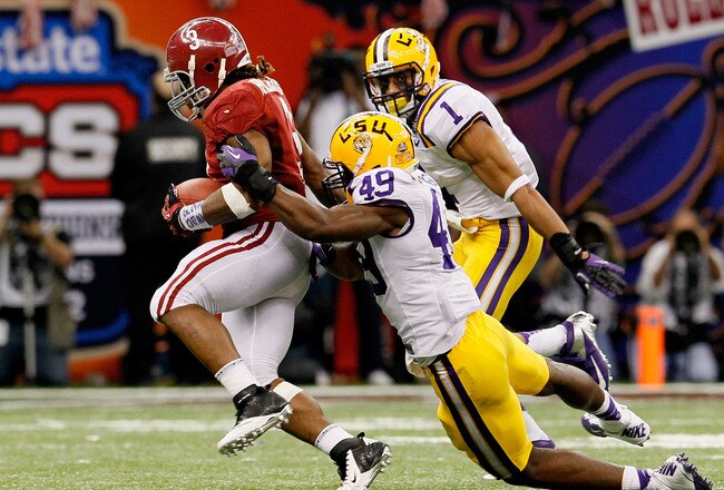 NEW ORLEANS, LA - JANUARY 09:  Trent Richardson #3 of the Alabama Crimson Tide breaks a tackle from Barkevious Mingo #49 of the Louisiana State University Tigers on his way to a 34-yard touchdown run in the fourth quarter during the 2012 Allstate BCS National Championship Game at Mercedes-Benz Superdome on January 9, 2012 in New Orleans, Louisiana.  (Photo by Kevin C. Cox/Getty Images)