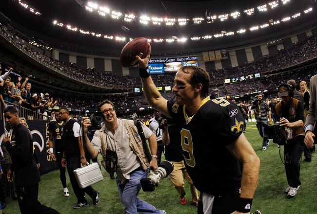 NEW ORLEANS, LA - JANUARY 07:   Drew Brees #9 of the New Orleans Saints holds the ball in the air as he runs off the field after defeating the Detroit Lions by a score of 45-28 to win during their 2012 NFC Wild Card Playoff game at Mercedes-Benz Superdome on January 7, 2012 in New Orleans, Louisiana.  (Photo by Chris Graythen/Getty Images)