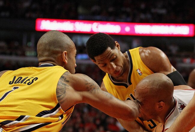 CHICAGO, IL - APRIL 26: Taj Gibson #22 of the Chicago Bulls gets hit in the face by Dahntay Jones #1 of the Indiana Pacers as he battles for the ball with (L-R) Jones, Danny Granger #33 and Josh McRoberts #32 in Game Five of the Eastern Conference Quarterfinals in the 2011 NBA Playoffs at the United Center on April 26, 2011 in Chicago, Illinois. The Bulls defeated the Pacers 116-89. NOTE TO USER: User expressly acknowledges and agrees that, by downloading and/or using this photograph, User is consenting to the terms and conditions of the Getty Images License Agreement. (Photo by Jonathan Daniel/Getty Images)