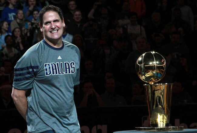 DALLAS, TX - DECEMBER 25:  Owner Mark Cuban of the Dallas Mavericks stands with the NBA trophy before a game against the Miami Heat on opening day of the NBA season at American Airlines Center on December 25, 2011 in Dallas, Texas.  NOTE TO USER: User expressly acknowledges and agrees that, by downloading and/or using this Photograph, user is consenting to the terms and conditions of the Getty Images License Agreement.  (Photo by Ronald Martinez/Getty Images)