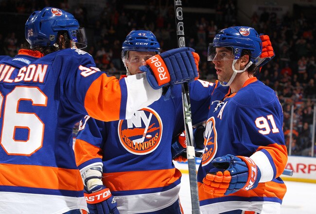 UNIONDALE, NY - JANUARY 10:  John Tavares #91 of the New York Islanders celebrates his goal with teammates Andrew MacDonald #47 and Matt Moulson #26 during their game on January10, 2012 at the Nassau Coliseum in Uniondale, New York.  (Photo by Al Bello/Getty Images)