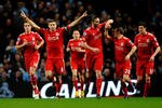 MANCHESTER, ENGLAND - JANUARY 11:  Steven Gerrard of Liverpool celebrates scoring the opening goal from a penalty kick with his team mates during the Carling Cup Semi Final First Leg match between Manchester City and Liverpool at the Etihad Stadium on January 11, 2012 in Manchester, England.  (Photo by Laurence Griffiths/Getty Images)
