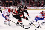 OTTAWA, ON - DECEMBER 27:  Erik Karlsson #65 of the Ottawa Senators cuts between Josh Gorges #26 and David Deshamais #51 of the Montreal Canadiens as he takes the puck hard to the net in a game at Scotiabank Place on December 27, 2011 in Ottawa, Canada.  (Photo by Phillip MacCallum/Getty Images)