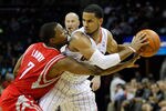 CHARLOTTE, NC - JANUARY 10:  Kyle Lowry #7 of the Houston Rockets tries to steal the ball away from D.J. Augustin #14 of the Charlotte Bobcats during their game at Time Warner Cable Arena on January 10, 2012 in Charlotte, North Carolina.   NOTE TO USER: User expressly acknowledges and agrees that, by downloading and or using this photograph, User is consenting to the terms and conditions of the Getty Images License Agreement.  (Photo by Streeter Lecka/Getty Images)