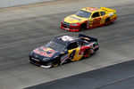 DOVER, DE - OCTOBER 02:  Kasey Kahne, driver of the #4 Red Bull Toyota, leads Kurt Busch, driver of the #22 Shell/Pennzoil Dodge, during the NASCAR Sprint Cup Series AAA 400 at Dover International Speedway on October 2, 2011 in Dover, Delaware.  (Photo by Chris Graythen/Getty Images)