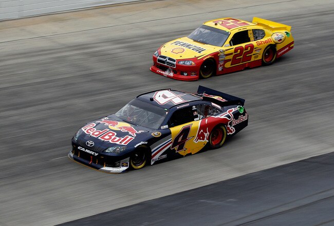 DOVER, DE - OCTOBER 02:  Kasey Kahne, driver of the #4 Red Bull Toyota, leads Kurt Busch, driver of the #22 Shell/Pennzoil Dodge, during the NASCAR Sprint Cup Series AAA 400 at Dover International Speedway on October 2, 2011 in Dover, Delaware.  (Photo by Chris Graythen/Getty Images)
