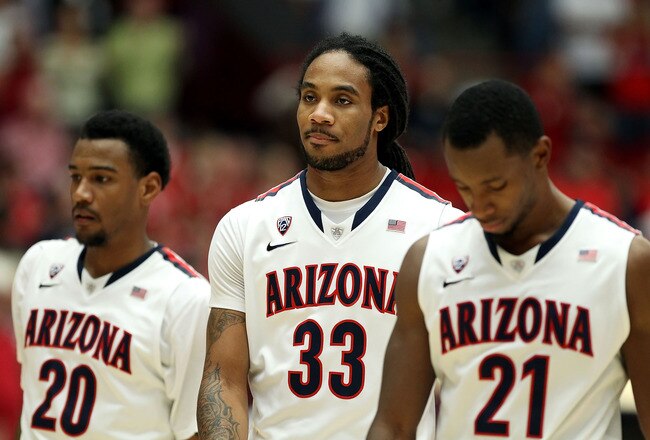TUCSON, AZ - DECEMBER 10:  Jesse Perry #33 (C) of the Arizona Wildcats walks with teammates Jordin Mayes #20 and Kyle Fogg #21 during the college basketball game against the Clemson Tigers at McKale Center on December 10, 2011 in Tucson, Arizona. The Wildcats defeated the Tigers 63-47.  (Photo by Christian Petersen/Getty Images)
