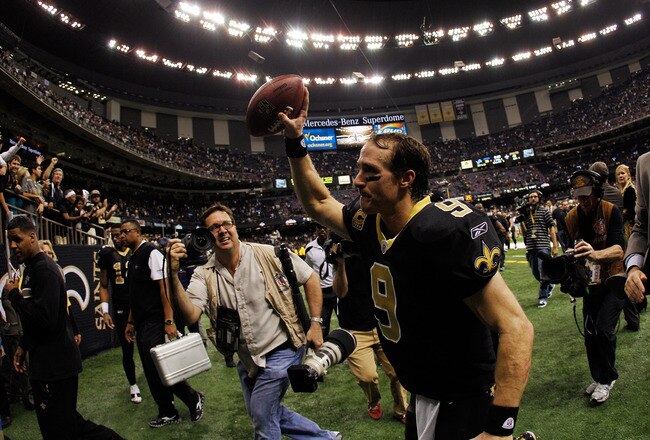 NEW ORLEANS, LA - JANUARY 07:   Drew Brees #9 of the New Orleans Saints holds the ball in the air as he runs off the field after defeating the Detroit Lions by a score of 45-28 to win during their 2012 NFC Wild Card Playoff game at Mercedes-Benz Superdome on January 7, 2012 in New Orleans, Louisiana.  (Photo by Chris Graythen/Getty Images)