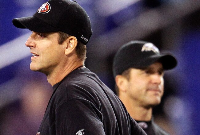 BALTIMORE, MD - NOVEMBER 24:  Head coach Jim Harbaugh (L) of the San Francisco 49ers and his brother, head coach John Harbaugh (R) of the Baltimore Ravens stand next to each other before the start of their game at M&T Bank Stadium on November 24, 2011 in Baltimore, Maryland.  (Photo by Rob Carr/Getty Images)