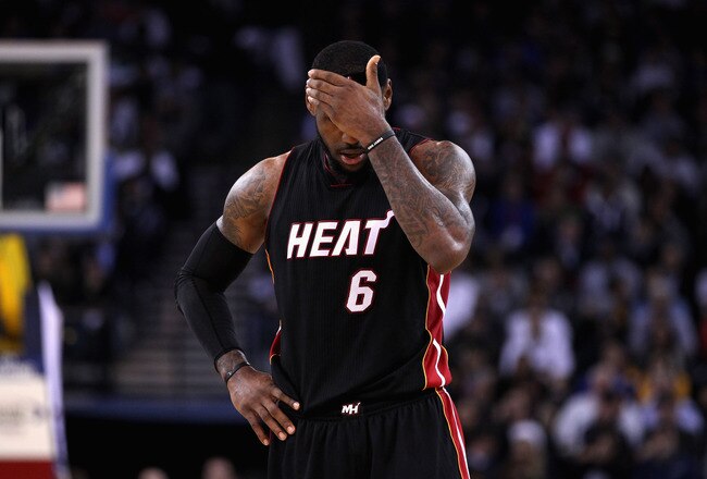 OAKLAND, CA - JANUARY 10:  LeBron James #6 of the Miami Heat rubs his head during their loss to the Golden State Warriors at Oracle Arena on January 10, 2012 in Oakland, California.  NOTE TO USER: User expressly acknowledges and agrees that, by downloading and or using this photograph, User is consenting to the terms and conditions of the Getty Images License Agreement.  (Photo by Ezra Shaw/Getty Images)