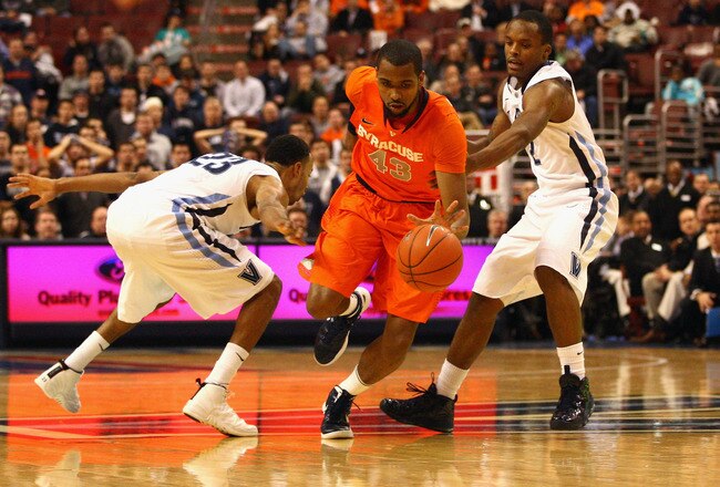 PHILADELPHIA, PA - JANUARY 11:  James Southerland #43 of the Syracuse Orange drives against Dominic Cheek #23 (L) and Maalik Wayns #2 of the Villanova Wildcats at the Wells Fargo Center on January 11, 2012 in Philadelphia, Pennsylvania.  (Photo by Chris Chambers/Getty Images)