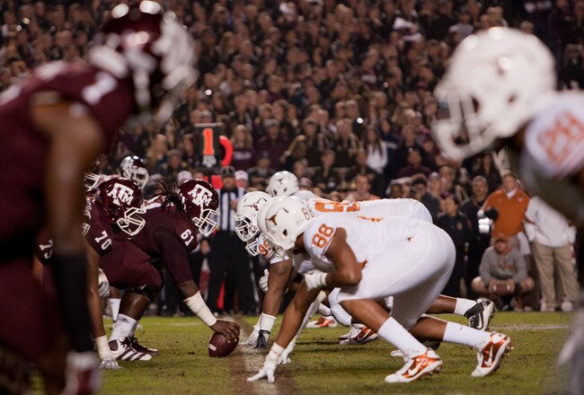 COLLEGE STATION, TX - NOVEMBER 24:  Patrick Lewis #61 of the Texas A&M Aggies prepares to snap the ball against the Texas Longhorns in the second half of a game at Kyle Field on November 24, 2011 in College Station, Texas. (Photo by Darren Carroll/Getty Images)