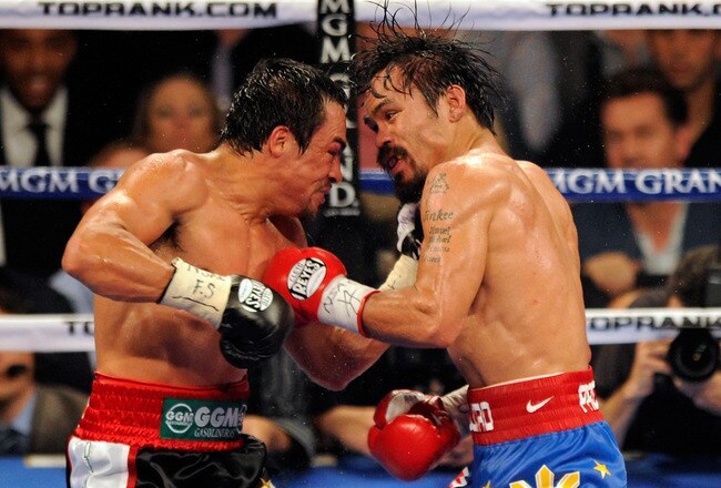 LAS VEGAS, NV - NOVEMBER 12:  Juan Manuel Marquez (L) and Manny Pacquiao battle in the 10th round of their WBO world welterweight title fight at the MGM Grand Garden Arena November 12, 2011 in Las Vegas, Nevada. Pacquiao retained his title with a majority decision victory.  (Photo by Ethan Miller/Getty Images)