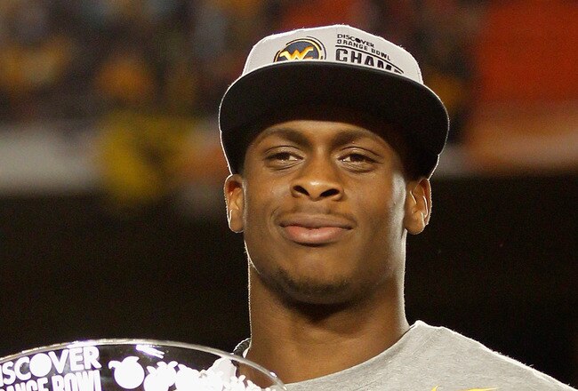 MIAMI GARDENS, FL - JANUARY 04:  Geno Smith #12 of the West Virginia Mountaineers celebrates with the trophy after they won 70-33 against the Clemson Tigers during the Discover Orange Bowl at Sun Life Stadium on January 4, 2012 in Miami Gardens, Florida.  (Photo by Mike Ehrmann/Getty Images)