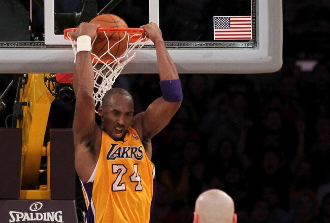 LOS ANGELES, CA - JANUARY 10:  Kobe Bryant #24 of the Los Angeles Lakers reverse dunks over Grant Hill #33 and Marcin Gortat #4 of the Phoenix Suns at Staples Center on January 10, 2012 in Los Angeles, California. The Lakers won 99-83. NOTE TO USER: User expressly acknowledges and agrees that, by downloading and or using this photograph, User is consenting to the terms and conditions of the Getty Images License Agreement.  (Photo by Stephen Dunn/Getty Images)