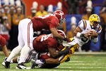 NEW ORLEANS, LA - JANUARY 09:  Jordan Jefferson #9 of the Louisiana State University Tigers is sacked late in the second quarter by the Alabama Crimson Tide during the 2012 Allstate BCS National Championship Game at Mercedes-Benz Superdome on January 9, 2012 in New Orleans, Louisiana.  (Photo by Andy Lyons/Getty Images)