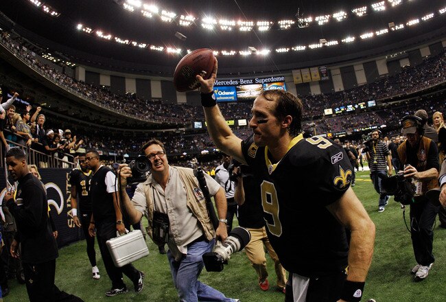 NEW ORLEANS, LA - JANUARY 07:   Drew Brees #9 of the New Orleans Saints holds the ball in the air as he runs off the field after defeating the Detroit Lions by a score of 45-28 to win during their 2012 NFC Wild Card Playoff game at Mercedes-Benz Superdome on January 7, 2012 in New Orleans, Louisiana.  (Photo by Chris Graythen/Getty Images)