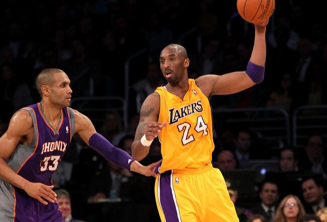 LOS ANGELES, CA - JANUARY 10:  Kobe Bryant #24 of the Los Angeles Lakers controls the ball against Grant Hill #33 of the Phoenix Suns at Staples Center on January 10, 2012 in Los Angeles, California. The Lakers won 99-83. NOTE TO USER: User expressly acknowledges and agrees that, by downloading and or using this photograph, User is consenting to the terms and conditions of the Getty Images License Agreement.  (Photo by Stephen Dunn/Getty Images)