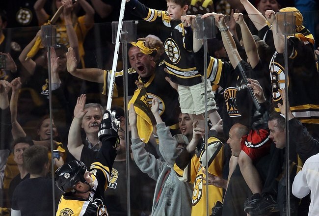 BOSTON - MAY 01:  Marc Savard #91 of the Boston Bruins hands his stick off to a fan after the game against the Philadelphia Flyers in Game One of the Eastern Conference Semifinals during the 2010 NHL Stanley Cup Playoffs at TD Garden on May 1, 2010 in Boston, Massachusetts. The Bruins defeated the Flyers 5-4 in overtime.  (Photo by Elsa/Getty Images)