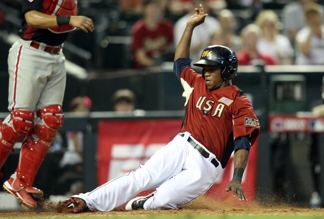 PHOENIX, AZ - JULY 10:  U.S. Futures All-Star Tim Beckham #22 of the Tampa Bay Rays slides safely to score a run in the eighth inning during the 2011 XM All-Star Futures Game at Chase Field on July 10, 2011 in Phoenix, Arizona.  (Photo by Christian Petersen/Getty Images)