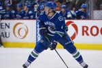 VANCOUVER, CANADA - DECEMBER 4: Keith Ballard #4 of the Vancouver Canucks skates with the puck during NHL action on December 04, 2011 against the Calgary Flames at Rogers Arena in Vancouver, British Columbia, Canada.  (Photo by Rich Lam/Getty Images)