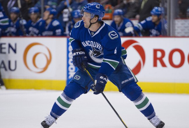 VANCOUVER, CANADA - DECEMBER 4: Keith Ballard #4 of the Vancouver Canucks skates with the puck during NHL action on December 04, 2011 against the Calgary Flames at Rogers Arena in Vancouver, British Columbia, Canada.  (Photo by Rich Lam/Getty Images)
