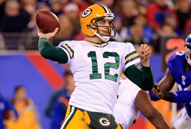 EAST RUTHERFORD, NJ - DECEMBER 04:  Aaron Rodgers #12 of the Green Bay Packers throws a pass against the New York Giants at MetLife Stadium on December 4, 2011 in East Rutherford, New Jersey. The Packers won 38-35.  (Photo by Chris Trotman/Getty Images)