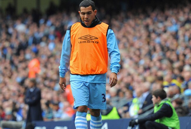 MANCHESTER, ENGLAND - SEPTEMBER 24:  Carlos Tevez of Manchester City looks on from the sidelines during the Barclays Premier League match between Manchester City and Everton at the Etihad Stadium on September 24, 2011 in Manchester, England.  (Photo by Michael Regan/Getty Images)