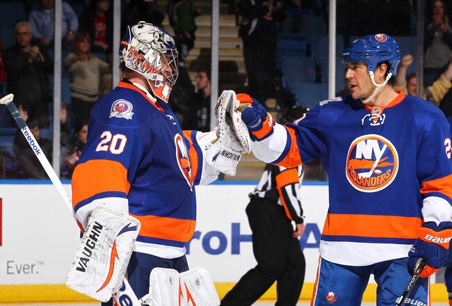 UNIONDALE, NY - JANUARY 10:  Evgeni Nabokov #20 of the New York Islanders celebrates with teammate Steve Staios #24 after a 5-1 win during their game against the Detroit Red Wings  Coliseum in Uniondale, New York.  (Photo by Al Bello/Getty Images)
