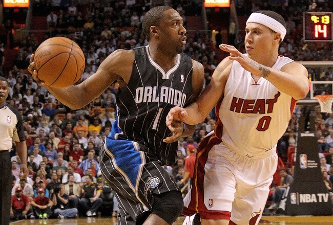 MIAMI, FL - MARCH 03: Gilbert Arenas #1 of the Orlando Magic drives against Mike Bibby #0 of the Miami Heat during a game at American Airlines Arena on March 3, 2011 in Miami, Florida. NOTE TO USER: User expressly acknowledges and agrees that, by downloading and/or using this Photograph, User is consenting to the terms and conditions of the Getty Images License Agreement.  (Photo by Mike Ehrmann/Getty Images)