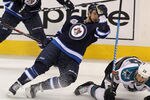 WINNIPEG, CANADA - JANUARY 12: Alexander Burmistrov #8 of the Winnipeg Jets collides with Ryane Clowe #29 of the San Jose Sharks in NHL action at the MTS Centre on January 12, 2012 in Winnipeg, Manitoba, Canada. (Photo by Marianne Helm/Getty Images)