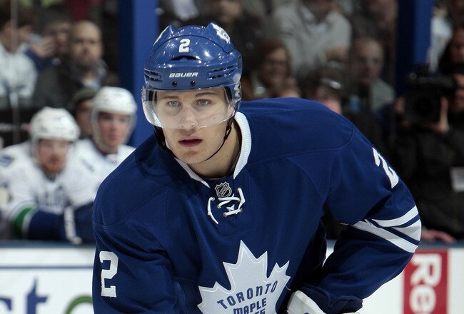 TORONTO, CANADA - DECEMBER 17: Luke Schenn #2 of the Toronto Maple Leafs prepares for a faceoff during NHL action against the Vancouver Canucks at The Air Canada Centre December 17, 2011 in Toronto, Ontario, Canada. (Photo by Abelimages/Getty Images)