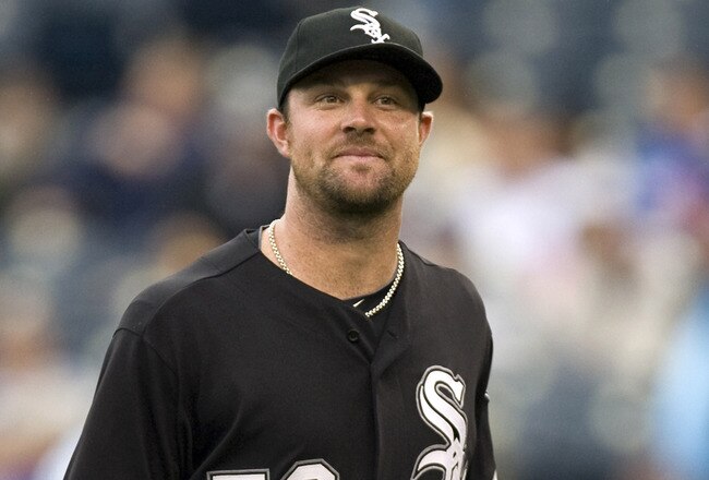KANSAS CITY, MO - SEPTEMBER 18:   Starting pitcher John Danks #50 of the Chicago White Sox smiles as he walks to the dugout after being relieved in the seventh inning during a game against the Kansas City Royals at Kauffman Stadium on September 18, 2011 in Kansas City, Missouri. (Photo by Ed Zurga/Getty Images)