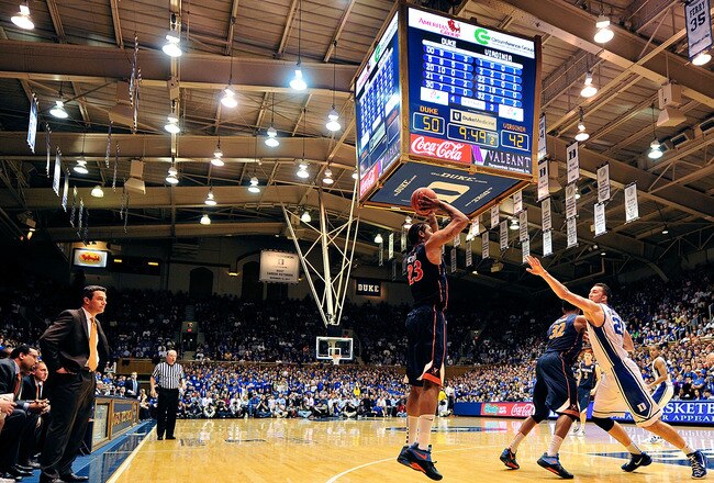 DURHAM, NC - JANUARY 12:  Coach Tony Bennett watches as Mike Scott #23 of the Virginia Cavaliers shoots a three-point shot against the Duke Blue Devils during play at Cameron Indoor Stadium on January 12, 2012 in Durham, North Carolina. Duke won 61-58.  (Photo by Grant Halverson/Getty Images)