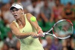PERTH, AUSTRALIA - JANUARY 04:  Caroline Wozniacki of Denmark plays a shot in her singles match against Tsvetana Pironkova of Bulgaria during day five of the 2012 Hopman Cup at The Burswood Dome on January 4, 2012 in Perth, Australia.  (Photo by Paul Kane/Getty Images)