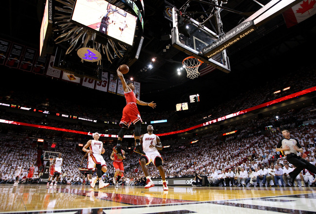 MIAMI, FL - MAY 24:  Derrick Rose #1 of the Chicago Bulls dunks against LeBron James #6 and Mike Bibby #0 of the Miami Heat in Game Four of the Eastern Conference Finals during the 2011 NBA Playoffs on May 24, 2011 at American Airlines Arena in Miami, Florida. NOTE TO USER: User expressly acknowledges and agrees that, by downloading and or using this photograph, User is consenting to the terms and conditions of the Getty Images License Agreement.  (Photo by Mike Ehrmann/Getty Images)