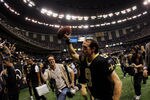 NEW ORLEANS, LA - JANUARY 07:   Drew Brees #9 of the New Orleans Saints holds the ball in the air as he runs off the field after defeating the Detroit Lions by a score of 45-28 to win during their 2012 NFC Wild Card Playoff game at Mercedes-Benz Superdome on January 7, 2012 in New Orleans, Louisiana.  (Photo by Chris Graythen/Getty Images)
