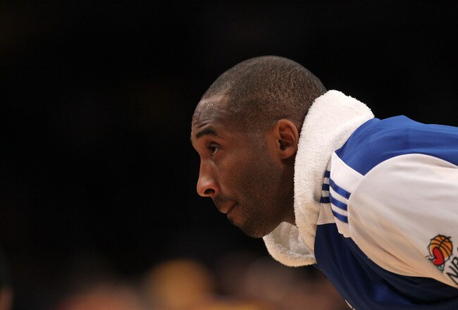LOS ANGELES, CA - JANUARY 11:   Kobe Bryant #24 of the Los Angeles Lakers stretches during the game wtih the Cleveland Cavaliers at Staples Center on January 11, 2011 in Los Angeles, California.  The Lakers won 112-57.  NOTE TO USER: User expressly acknowledges and agrees that, by downloading and or using this photograph, User is consenting to the terms and conditions of the Getty Images License Agreement. (Photo by Stephen Dunn/Getty Images)